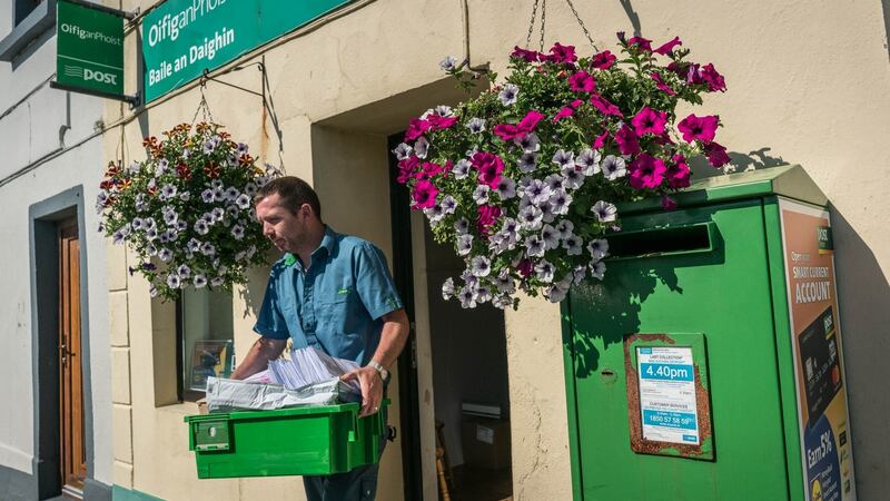 Postman Paul Mullaney collects the final post on the last day of business at Ballindine post office. Photograph: Keith Heneghan