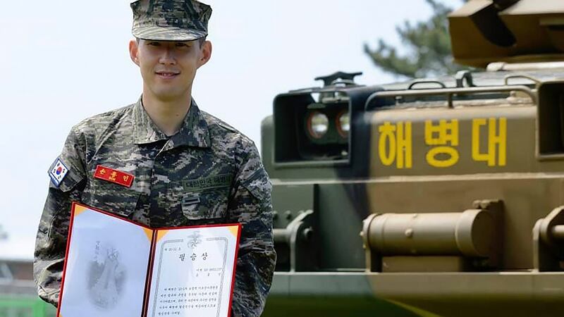 Son Heung-min poses with a prize during a basic military training completion ceremony. Photograph: AP