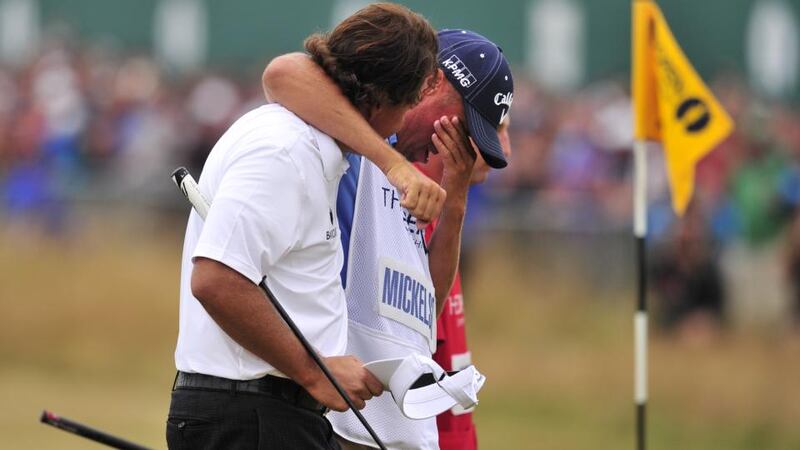 Phil Mickelson walks with his emotinally-overcome caddie Jim Mackay after scoring a birdie on the  18th green to secure victory in the 2013 British Open at Muirfield. Photograph:  Glyn Kirk/AFP/Getty Images)