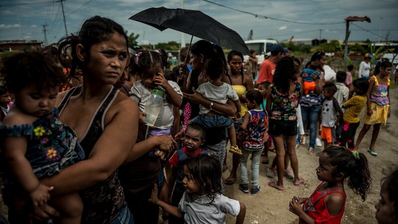 Families line up at a free children’s health clinic in Morón, Venezuela. Photograph:  Meridith Kohut/The New York Times