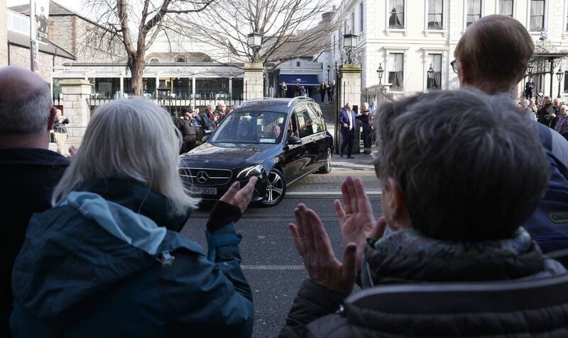 Crowds applaud as the remains of former RTÉ journalist Charlie Bird are brought from the Mansion House in Dublin after his memorial service. Photograph: Laura Hutton