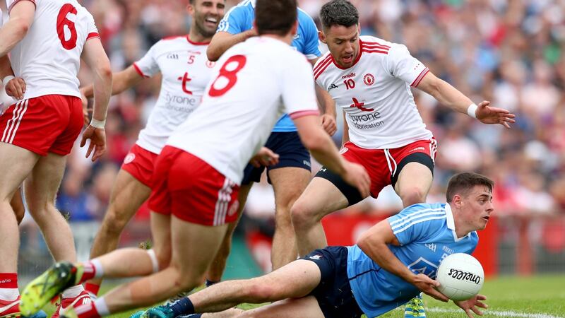 Tyrone players close in on Dublin’s Brian Howard. Their   message could be: ‘we aren’t allowing you to draw us out. But see when you do attack, we will be here, we will be waiting, we will turn you over’. Photograph:  James Crombie/Inpho