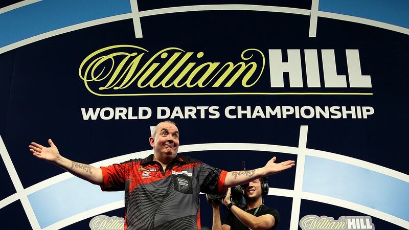 Phil Taylor will bow out in the World Championship final after beating Jamie Lewis 6-1. Photograph: Steve Paston/PA