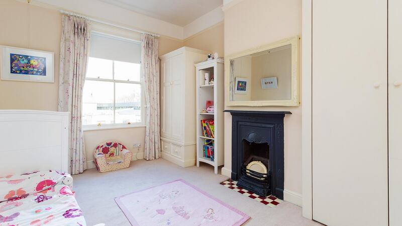 A comfortable home in creamy colours: one of the bedrooms at 2 Northbrook Villas