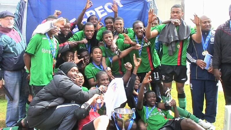 George Nkencho, right hand side with grey jumper around his neck, with the Insaka football team. Photograph: Max Mauro