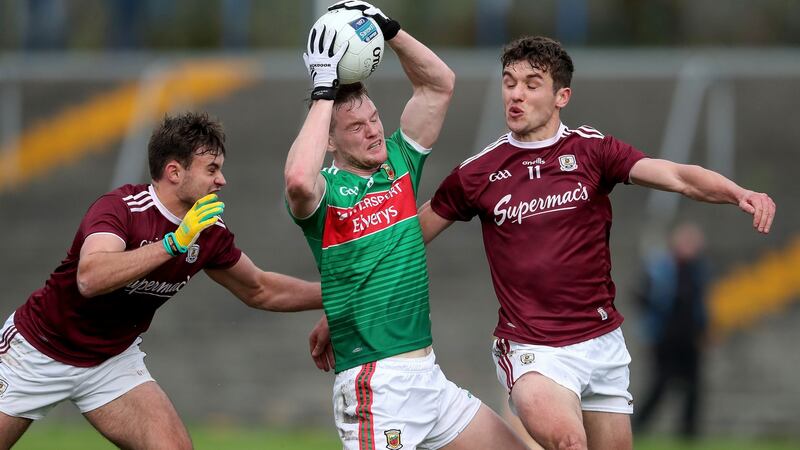 Mayo’s Matthew Ruane is tackled by Cillian McDaid and Michael Daly of Galway. Photograph: Bryan Keane/Inpho