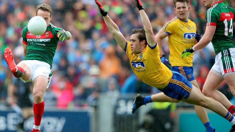 Andy Moran shoots as David Murray dives out to block him down. Photograph: James Crombie/Inpho
