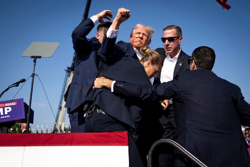 Secret service agents surround Donald Trump after he was shot at a rally last weekend. Photograph:  Doug Mills/The New York Times
                      