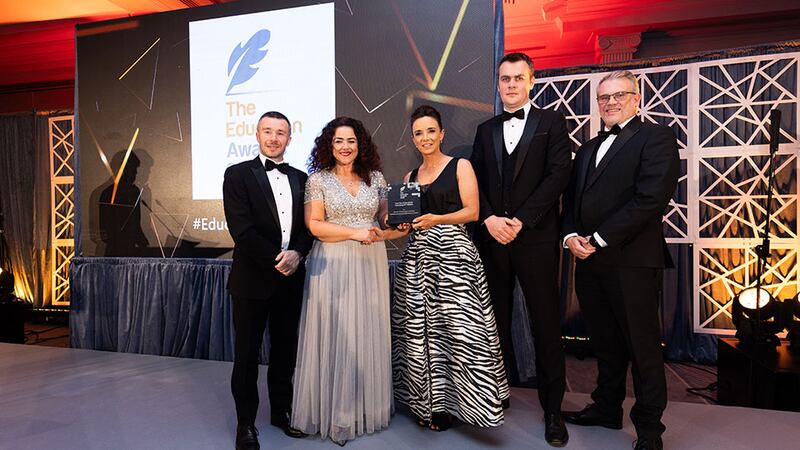 Denise McMorrow, awards judge, presents the best use of educational technology/ICT initiative award to the Munster Technological University team