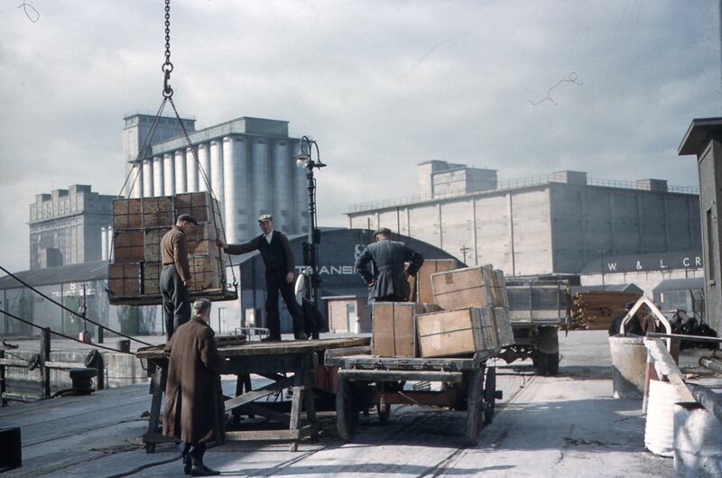 Cargo is loaded onto a trailer at the quayside with Odlums Mill in the background (circa 1950s). Photograph: Dublin Port Archive