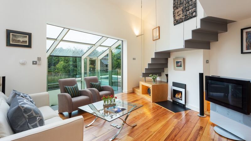 Open-plan living area with stairs up to mezzanine.