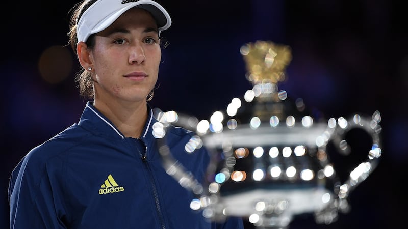 Runner-up Garbine Muguruza looks at the trophy after her Australian Open final defeat. Photograph: Hannah Peters/Getty