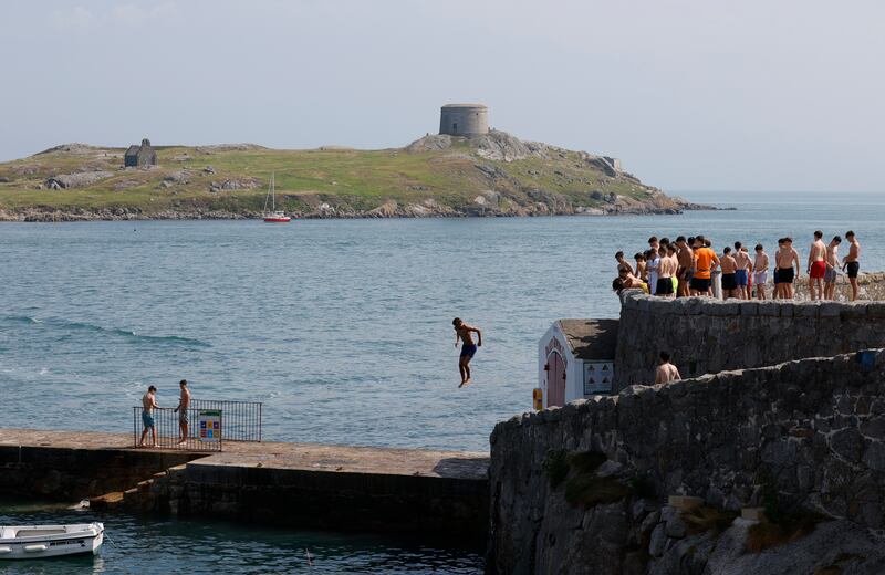 Jumping into the sea at Coliemore Harbour in south Dublin, with Dalkey Island in the background. Photograph: Nick Bradshaw