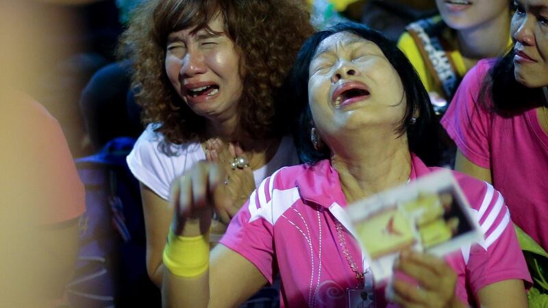 Thai women cry and mourn as they hear the news of the death of King Bhumibol Adulyadej outside Siriraj Hospital in Bangkok on Thursday. Photograph: Diego Azubel/EPA