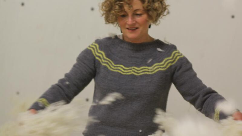 Joan Lucey of Yarn Vibes inspecting wool at Donegal Yarns.