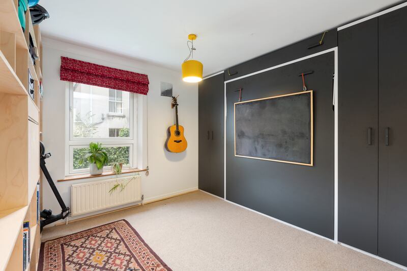 When the Murphy bed is closed, the room can be used an office or a space for yoga