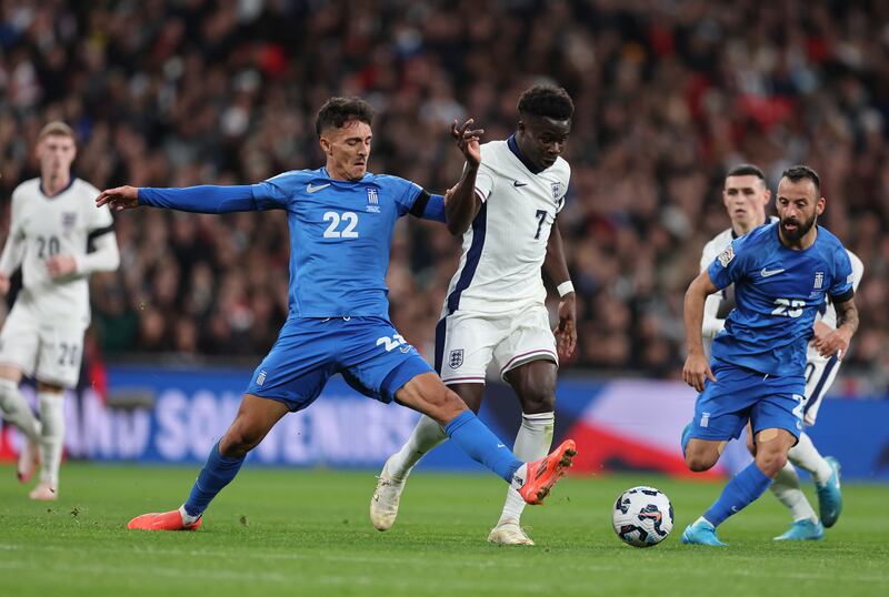 Bukayo Saka of England is tackled by Dimitris Giannoulis of Greece. Photograph: Catherine Ivill - AMA/Getty Images