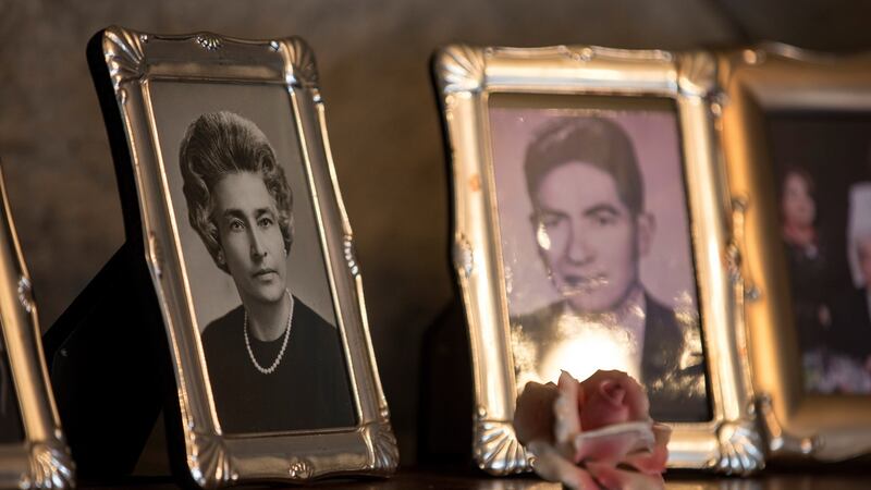 View of pictures at the house of Ecuadorians Julio Cesar Mora Tapia (R), 110, and Waldramina Maclovia Quinteros (L), 104, during an interview in Quito, Ecuador, 26 August 2020. Photograph: Jose Jacome/EPA