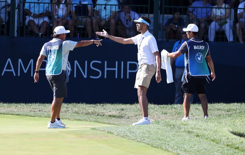 Rory McIlroy's caddy Harry Diamond and Scott Stallings's caddy John Yarbrough try to remove a fan after he came on to the green during the third round of the BMW Championship at Wilmington Country Club in  Delaware. Photograph: Rob Carr/Getty Images