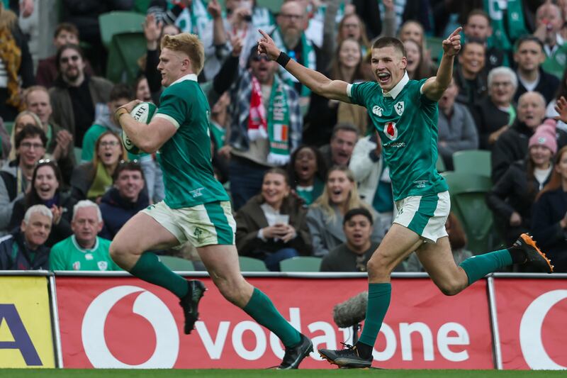 Ireland's Sam Prendergast celebrates as Tommy O'Brien runs in to score his sides sixth try of the match. Photograph: Gary Carr/Inpho