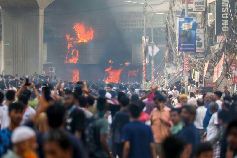 Protesters set Mirpur police box on fire as demonstrators clash with police. Photograph: Monirul Alam/EPA