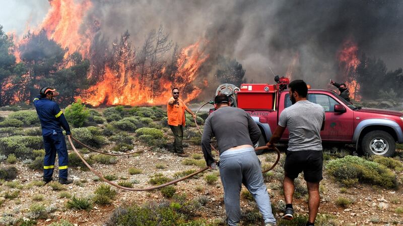 Firefighters and volunteers try to extinguish a wildfire raging in Verori, near Loutraki city, Peloponnese, southern Greece, on Tuesday. Photograph: Vassilis Psomas/EPA