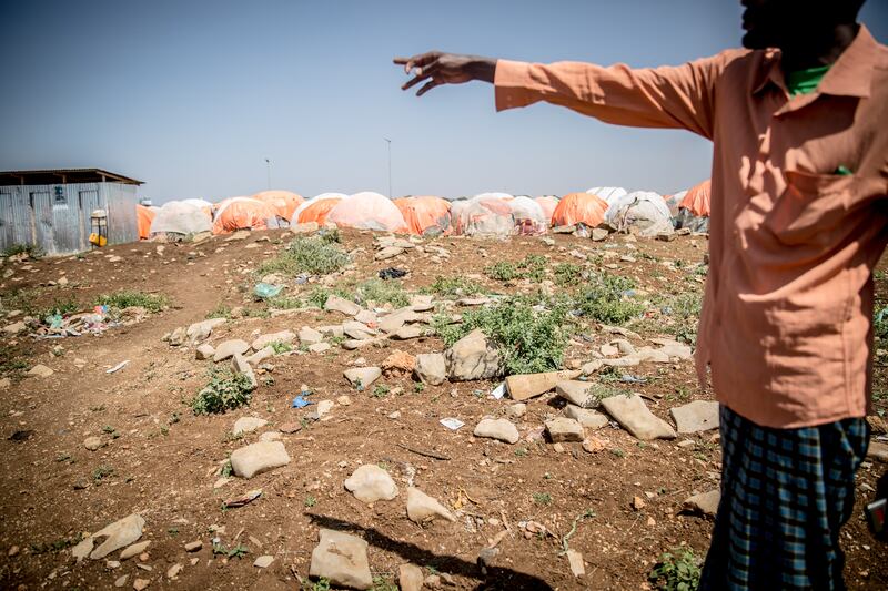 A local leader points out 14 graves of children who have recently died from malnutrition and measles in the Edaan Qaboobe displaced persons site in Baidoa, Somalia. Photograp: Sally Hayden