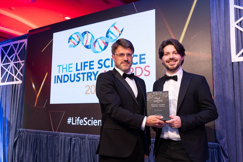 Roy Fahy, operations director at Unispace Life Sciences, presents the life sciences company of the year – medium award to Ronan Scott, Arrotek Medical