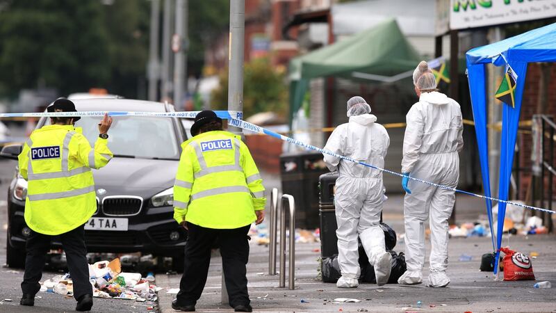Police officers and forensics at the scene in Claremont Road, Moss Side, Manchester, where several people have been injured after a shooting. Photograph: Peter Byrne/PA Wire