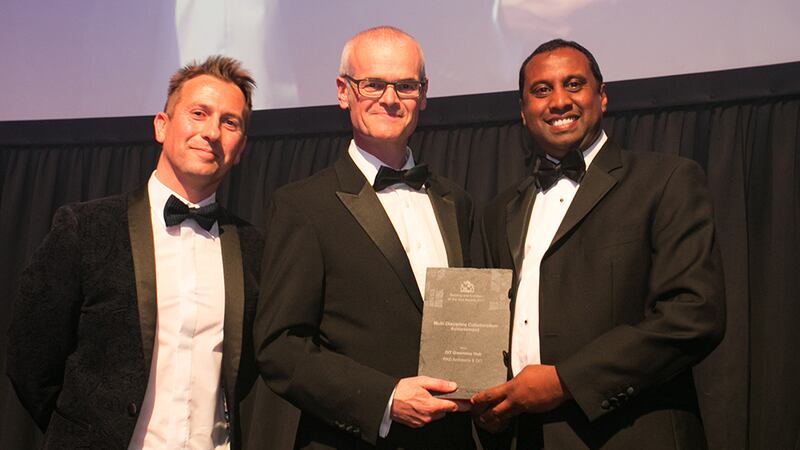 Stephen Pierce, senior area manager, Vescom Wallcoverings & Fabrics presents the Multi-Discipline Collaboration Achievement Award to Gopal Naidoo and Donal Murphy, RKD Architects.