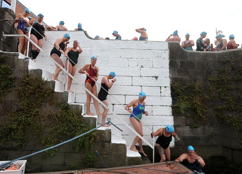 Swimmers descend from the quays to the starting pontoon. Photograph: Bryan Keane / Inpho