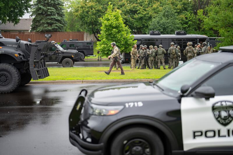 Law enforcement officers including local police, sheriffs and the FBI at the scene. Photograph: Alex Kormann/ Star Tribune via AP