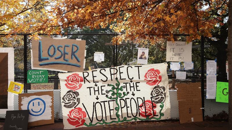 Signs critical of  Donald Trump hang on the the security fence that surrounds the White House this weekend. Photograph:  Chip Somodevilla/Getty Images