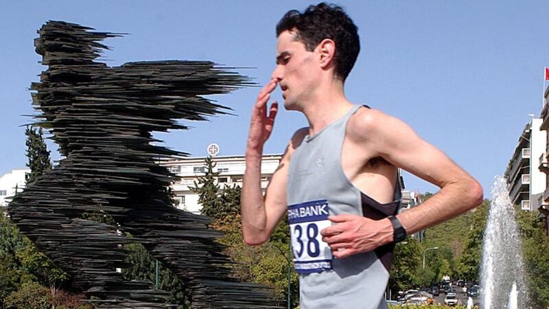 Ian O’Riordan from Ireland passes by the statue “The Runner” during the Athens Classic Marathon in 2003. Photograph: Orestis Panagioutou/EPA