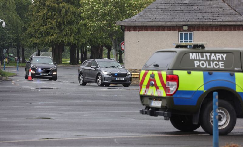 A convoy of Garda Cars leave through the front gates at Casement Aerodrome, Baldonnel, after An Aer Corps Airbus C-295 landed with Sean McGovern on board. Photograph: Alan Betson