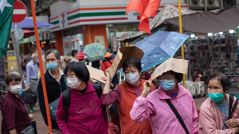 Elderly people wait for the distribution of free face masks in Sham Shui Po district in Hong Kong. Photograph: Jerome Favre/EPA