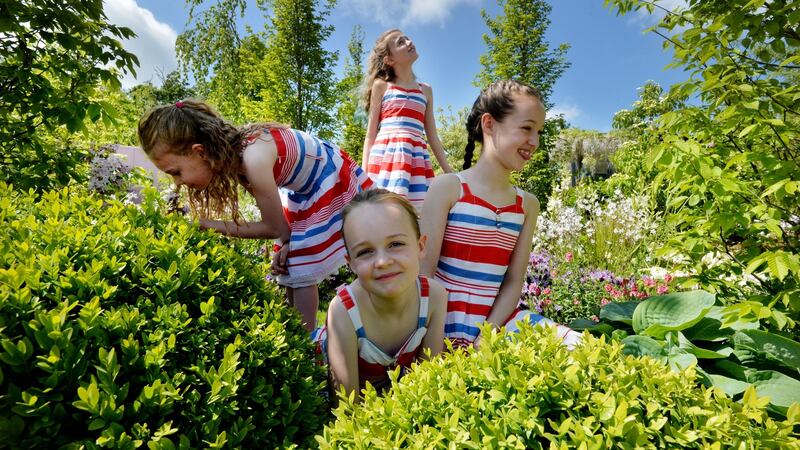 Siomhe Deevy, Nadine Bailey (centre), Brieanna Deevy (back) and Katelyn Bailey (right) from the Leah Moran Stage School in the Crumlin Children’s Hospital garden called “Back Garden Retreat”,  designed by Anthony Ryan, Kieran Dunne and Valerie Murray .Photograph: Alan Betson