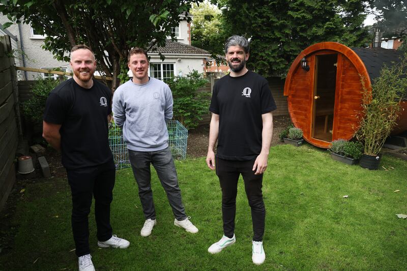 John Needham of Sauna Craft Co and Slainte Sauna (l), Matthew Dempsey, Sauna Craft and Ciaran O’Malley, also Sauna Craft, pictured with one of their saunas in John’s back garden in Kimmage, Dublin. Photograph: Bryan O’Brien
