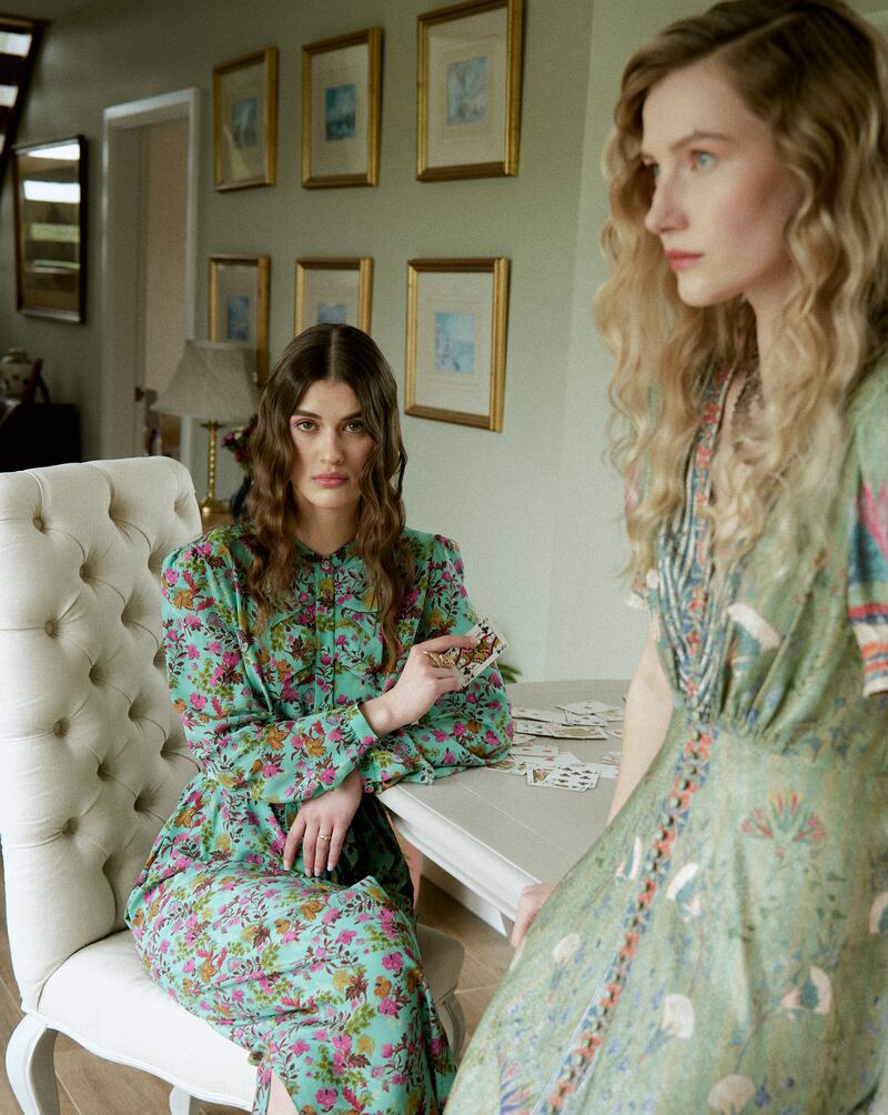 Sage printed dress, Saloni at Costume, €672; white cardigan, €108, Bow & Pearl; black beaded earrings and necklace set, Jenny Vander Vintage, €350.
Aqua floral dress, Saloni, €574, at Costume; clip-on floral earrings, Jenny Vander Vintage, €40.