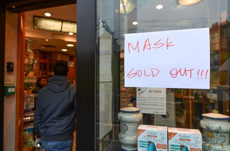 A man enters a pharmacy displaying on its window a board "mask sold out" in the Chinese district of Milan on Tuesday. Photograph: Miguel MEDINA/AFP/Getty Images