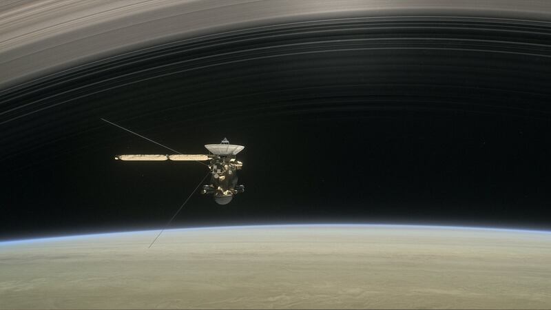 An artist’s rendering of ‘Cassini’ as the spacecraft makes one of its final five dives through Saturn’s upper atmosphere in August and September 2017