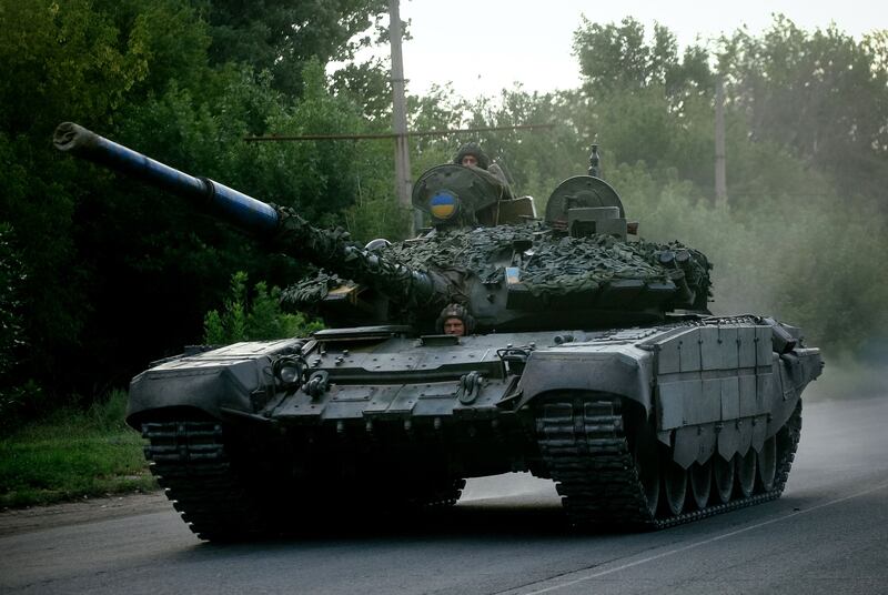 Ukrainian soldiers ride a tank on a road in the Donetsk region. Photograph: Anatolii Stepanov/AFP/Getty