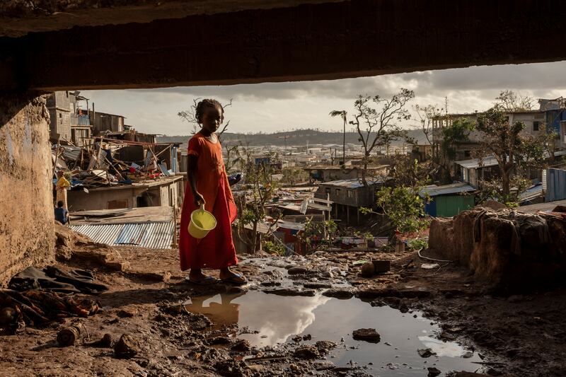 A young girl stands amid the devastation after Cyclone Chido. Photograph: Adrienne Surprenant/AP