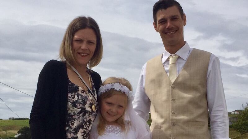 Mia Walker with her parents Sam and  Jamie on Arranmore on her Communion day