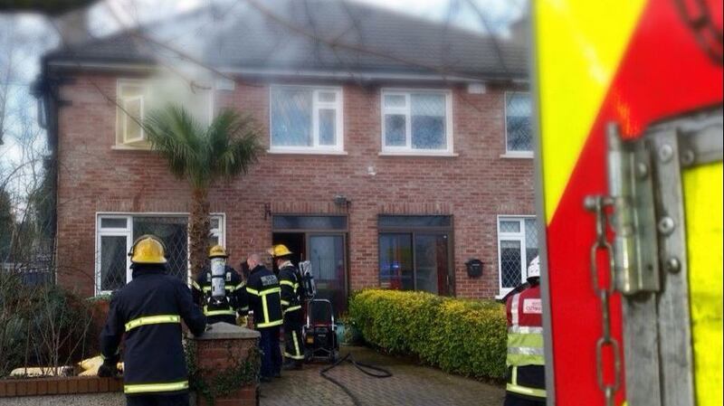 Smoke  emerges from a house in Esker, Lucan, Dublin, after an electric blanket went on fire. Photograph. Dublin Fire Brigade/Twitter