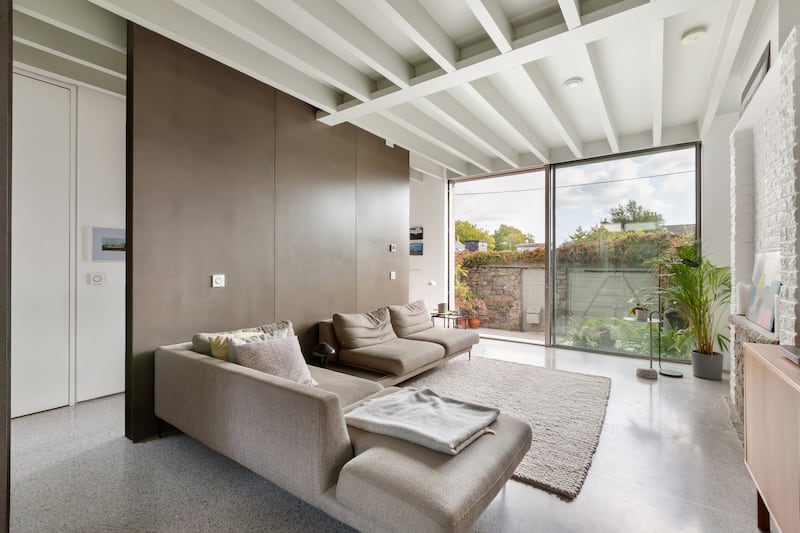 Exposed ceiling  timbers add interest as do sliding panels