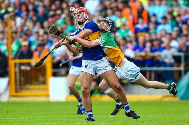 Tipperary’s Jack O’Callaghan is wrapped up by Offaly's Leigh Kavanagh. Photograph: Ken Sutton/Inpho