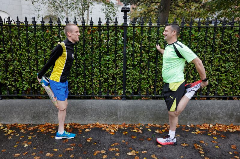The lows and highs of the long-distance runners: Gary Mills (left) and Dara O'Connor limber up before another invigorating run. Photograph: Alan Betson
