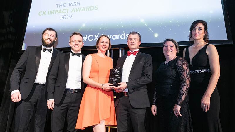 Aidan Connolly, CEO, Idiro Analytics presents the CX Team of the Year award to The Customer Service Hub Team, Passport Service, Department of Foreign Affairs and Trade.