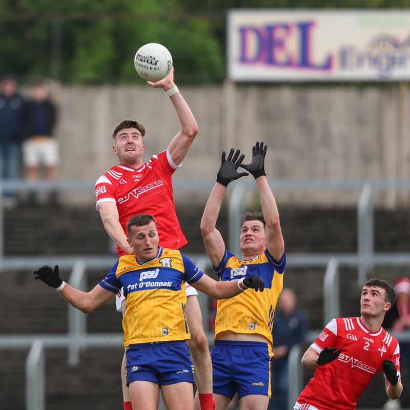 Louth's Dara McDonnell competes in the air with Keenan Sexton and Mark McInerney of Clare. Photograph: Ben Brady/Inpho